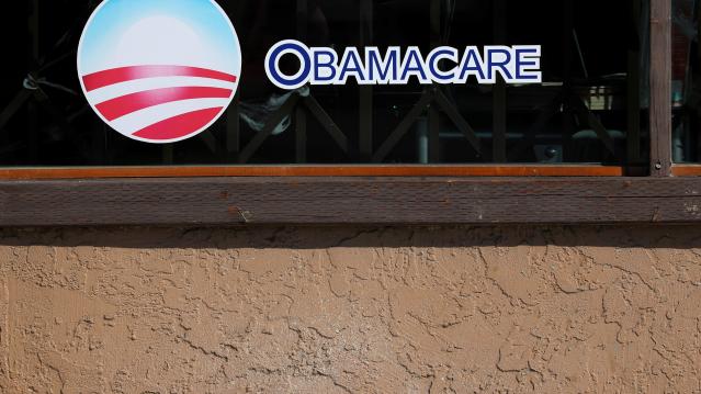 FILE PHOTO: A sign on an insurance store advertises Obamacare in San Ysidro