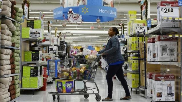 A customer pushes her shopping cart through the aisles at a Walmart store in the Porter Ranch section of Los Angeles November 26, 2013.  REUTERS/Kevork Djansezian 