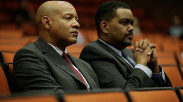 FILE PHOTO: Charlottesville Chief of Police Al Thomas (L) and Charlottesville City Manager Maurice Jones listen to speakers during a public forum hosted by the Department of Justice Community Relations Service after a rally by far-right demonstrators led
