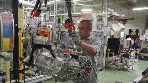 A employee handles the new R240 electric engine by French carmaker Renault for their Zoe model automobile at their factory in Cleon