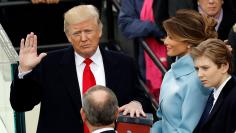 Donald Trump takes the oath of office with his wife Melania and son Barron at his side, during his inauguration at the U.S. Capitol in Washington