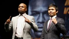 Manny Pacquiao and Floyd Mayweather pose at a news conference for their upcoming bout in Los Angeles