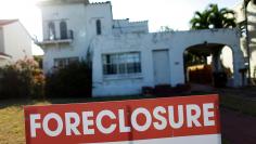 A foreclosure sale sign sits in front of a house in Miami Beach