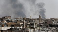 Smoke rises from clashes during the fight with the Islamic States militants in the Old City of Mosul