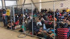 An overcrowded fenced area holding families at a Border Patrol station is seen in McAllen