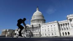 A cyclist passes the U.S. Capitol in Washington