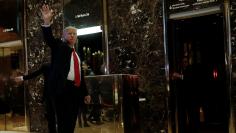 U.S. President-elect Donald Trump waves to supporters as he makes an appearance in the lobby at Trump Tower in New York