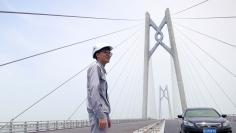 A worker stands on the Hong Kong-Zhuhai-Macau bridge under construction in Zhuhai