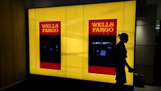 A customer leaves an ATM at the Wells Fargo & Co. bank in downtown Denver