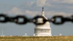 U.S. Capitol is photographed behind a chain fence in Washington