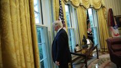 U.S. President Trump looks out window of the Oval Office following an interview with Reuters at the White House in Washington