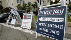 Signs advertising open houses for real estate sale are seen in Los Angeles
