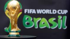 The 2014 FIFA World Cup Brazil trophy is displayed during its unveiling ceremony at a Soccerex event in Rio de Janeiro