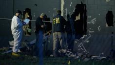 Police forensic investigators work at the crime scene of a mass shooting at the Pulse gay night club in Orlando