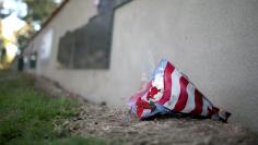 Flowers sit along the Rosie the Riveter Park Memorial Wall for fallen veterans in Long Beach