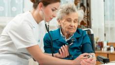 measuring blood pressure of senior woman