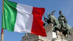 The Italian flag waves in front of The "Altare della Patria" also known as "Vittoriano" downtown Rome