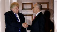 Andy Puzder, CEO of CKE Restaurants, shakes hands with U.S. President-elect Donald Trump in Bedminster