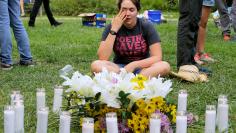 A local resident of Charlottesville cries at a vigil for the 19 people injured and one killed when a car plowed into counter protesters near the "Unite the Right" rally organized by white nationalists in Charlottesville