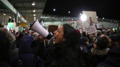 Protesters  gather outside Terminal 4 at JFK airport in opposition to U.S. President Donald Trump's proposed ban on immigration in Queen