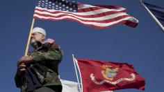 Navy Vietnam War veteran Dennis McClelland of Murrells Inlet, South Carolina, holds a U.S. flag during a Veterans March on Ocean Boulevard in honor of Memorial Day in Myrtle Beach