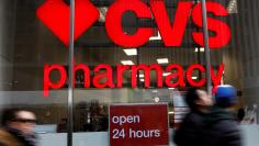 FILE PHOTO: People walk by a CVS Pharmacy store in the Manhattan borough of New York City, New York, U.S., November 30, 2017. REUTERS/Shannon Stapleton/File Photo