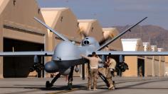 U.S. airmen prepare a U.S. Air Force MQ-9 Reaper drone as it leaves on a mission at Kandahar Air Field, Afghanistan March 9, 2016.  REUTERS/Josh Smith 