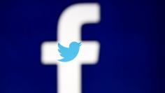 FILE PHOTO - A 3D-printed Facebook logo is displayed in front of the Twitter logo, in this illustration taken October 25, 2017. REUTERS/Dado Ruvic/Illustration 