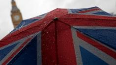 FILE PHOTO: A Union Flag umbrella is seen in front of the Elizabeth Tower, commonly known as Big Ben, in London