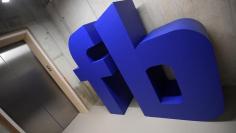 FILE PHOTO: A giant logo is seen at Facebook's headquarters in London