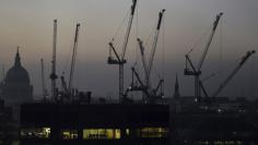 FILE PHOTO: Offices are seen at dusk as St. Paul's Cathedral and construction cranes are seen on the skyline in the City of London, Britain November 2, 2015.  REUTERS/Toby Melville