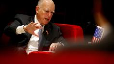 FILE PHOTO: California Governor Jerry Brown attends the International Forum on Electric Vehicle Pilot Cities and Industrial Development in Beijing, China June 6, 2017.   REUTERS/Thomas Peter/File Photo