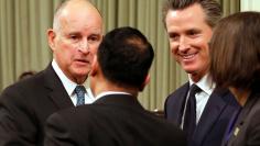 California Governor Jerry Brown and Lieutenant Governor Gavin Newsom greet well wishers after Brown delivered his final state of the state address in Sacramento