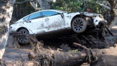 FILE PHOTO: A car sits tangled in debris after being destroyed by mudslides in Montecito
