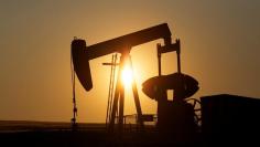 FILE PHOTO - An oil pump jack pumps oil in a field near Calgary