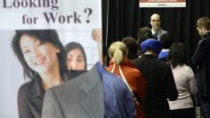 FILE PHOTO: People wait in line for resume critique and career assessment sessions at the 2014 Spring National Job Fair and Training Expo in Toronto, April 3, 2014. REUTERS/Aaron Harris  