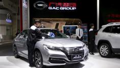 FILE PHOTO: A staff member cleans Honda brand's accord sedan model at the booth of Guangzhou Automobile Group during the Auto China 2016 auto show in Beijing