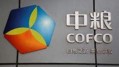 FILE PHOTO: The company logo of China Oil and Foodstuffs Corporation (COFCO) is seen at its headquarters in Beijing