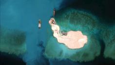 Satellite image of cargo being unloaded onto the shore of the Mischief Reef