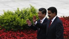 FILE PHOTO: Venezuela's President Nicolas Maduro (R) and Chinese President Xi Jinping respond to children waving the national flags from both countries at a welcoming ceremony outside the Great Hall of the People in Beijing September 22, 2013.  REUTERS/K