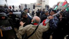 Palestinian security forces push away demonstrators from the convoy of Greek Orthodox Patriarch of Jerusalem Theophilos III, during a protest against his visit, in the West Bank city of Bethlehem