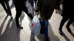 People carry shopping bags outside Macy's Herald Square in Manhattan, New York City, U.S., December 22, 2016. REUTERS/Andrew Kelly 