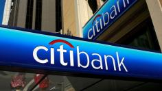 People walk beneath a Citibank branch logo in the financial district of San Francisco, California July 17, 2009. REUTERS/Robert Galbraith/File Photo