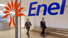 FILE PHOTO -  People walk past the logo of Italy's biggest utility Enel at their Rome headquarter November 11, 2014. REUTERS/Tony Gentile/File Photo                        GLOBAL BUSINESS WEEK AHEAD PACKAGE - SEARCH 'BUSINESS WEEK AHEAD 6 FEB'  FOR ALL I