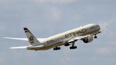 FILE PHOTO: An Etihad Airways Boeing 777-3FX company aircraft takes off at the Charles de Gaulle airport in Roissy, France, August 9, 2016. REUTERS/Jacky Naegelen/File Photo 