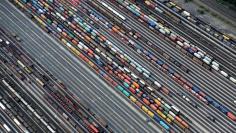 Containers and cars are loaded on freight trains at the railroad shunting yard in Maschen near Hamburg September 23, 2012.  REUTERS/Fabian Bimmer/File Photo                      