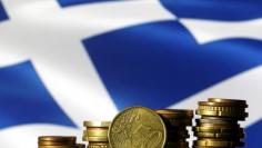 Euro coins are seen in front of a displayed Greece flag in this picture illustration, June 29, 2015. REUTERS/Dado Ruvic/File Photo 