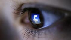A picture illustration shows a Facebook logo reflected in a person's eye, in Zenica, March 13, 2015. REUTERS/Dado Ruvic
