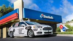 A Ford self-driving delivery vehicle is pictured in front of a Domino's pizza restaurant in this undated handout photo obtained by Reuters August 28, 2017.   Ford Motor Company/Handout via REUTERS