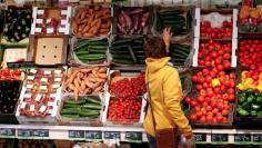  A woman checks vegetables at the Biocompany organic supermarket in Berlin, January 31, 2013. REUTERS/Fabrizio Bensch/Files